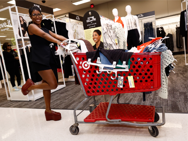 Jeneé Naylor poses with a Target shopping cart filled with items from her Future Collective collection.